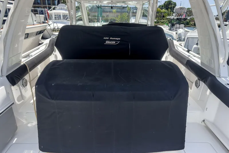 Slide: The Image of 2017 Boston Whaler 42 OUTRAGE boat interior with covered seating area. - 77