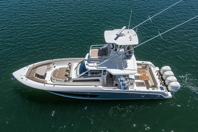 Slide: The Image of 2017 Boston Whaler 42 OUTRAGE boat on water, aerial view, showcasing sleek design and powerful engines. - 8
