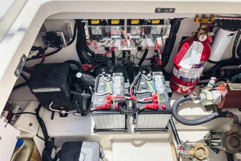 Slide: The Image of 2017 Boston Whaler 42 OUTRAGE engine compartment with batteries and fire extinguisher. - 89