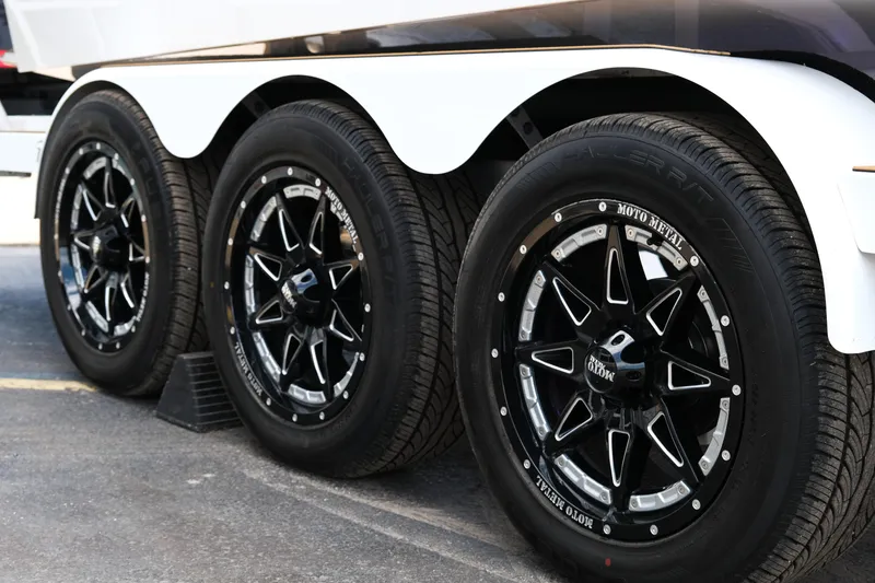 Slide: The Image of 2025 Supra SE450 trailer with black Moto Metal wheels and white fender. - 11