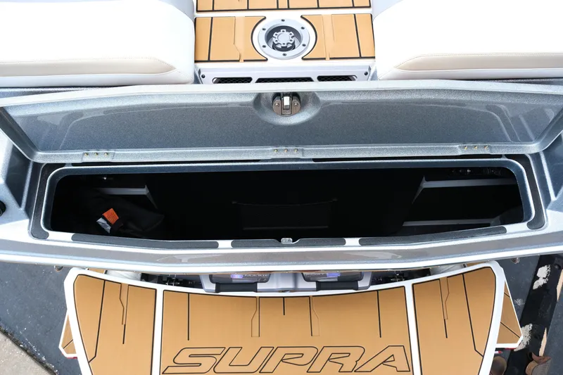 Slide: The Image of 2025 Supra SE450 boat storage compartment with open lid, showcasing spacious interior. - 15