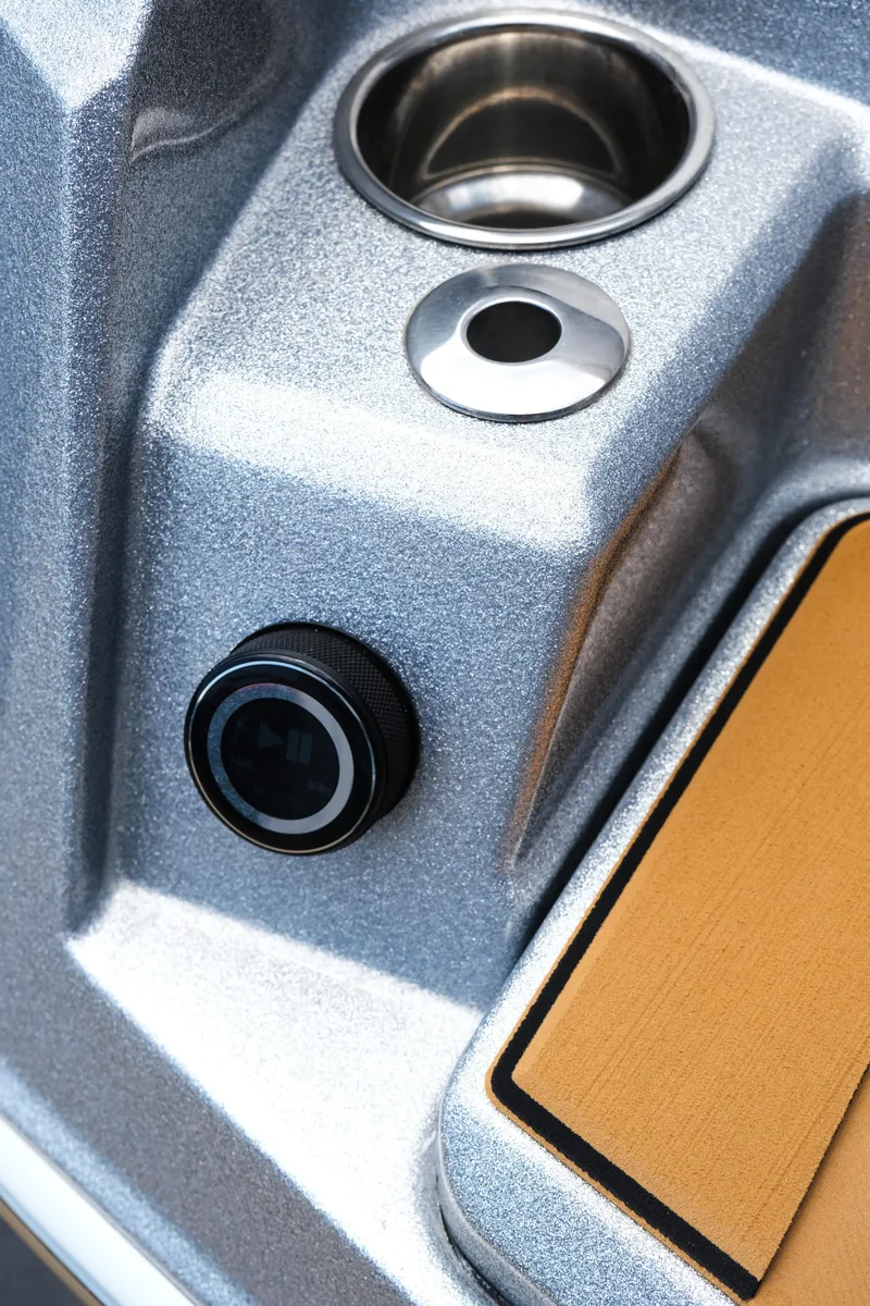 Slide: The Image of 2025 Supra SE450 boat control panel with cup holder and button. - 16