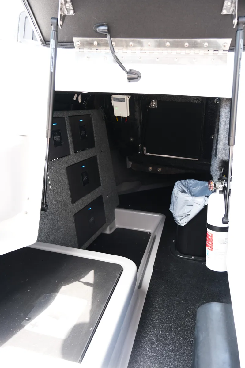 Slide: The Image of Interior of 2025 Supra SE450 boat, featuring storage compartments and safety equipment. - 25