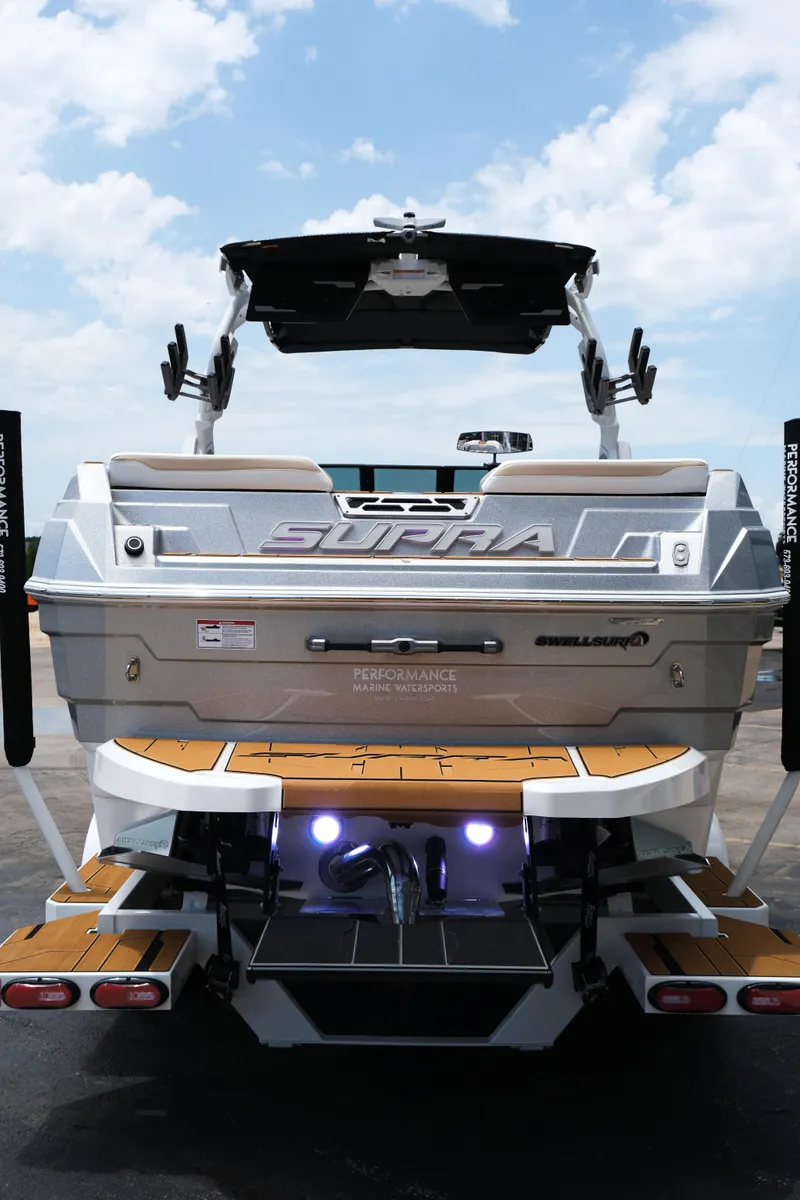 Slide: The Image of 2025 Supra SE450 boat rear view with teak deck and performance features. - 5