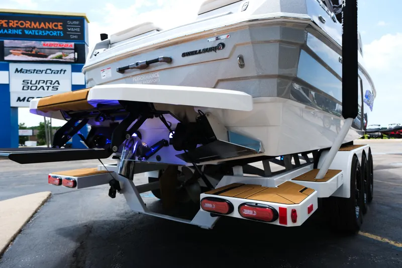 Slide: The Image of 2025 Supra SE450 boat on trailer at Performance Marine Watersports dealership. - 6