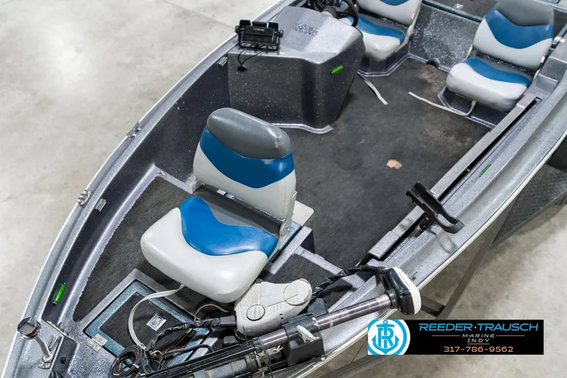 Slide: The Image of 1986 Phantom Panther boat interior with blue and gray seats, steering console, and fishing equipment. - 10