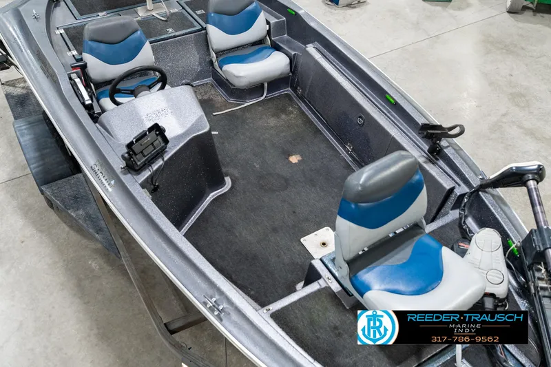 Slide: The Image of 1986 Phantom Panther boat interior with blue and gray seats, steering wheel, and control panel. - 11