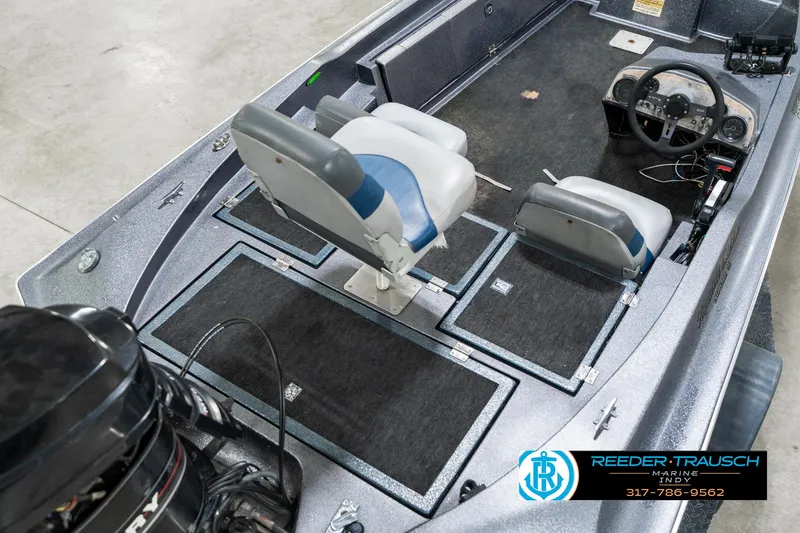 Slide: The Image of 1986 Phantom Panther boat interior with seating and steering wheel, featuring Reeder-Trausch Marine logo. - 12