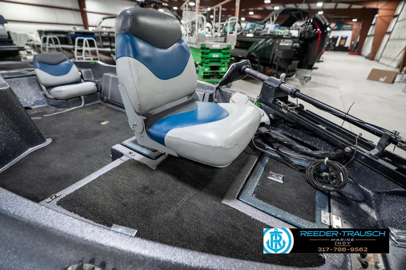 Slide: The Image of 1986 Phantom Panther boat interior with blue and gray seating in a showroom. - 20