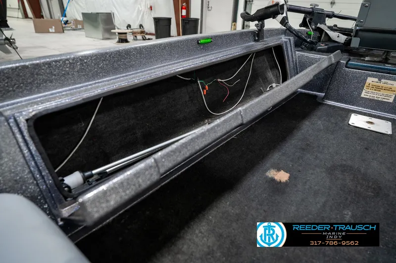 Slide: The Image of 1986 Phantom Panther boat interior with open storage compartment and visible wiring. - 24