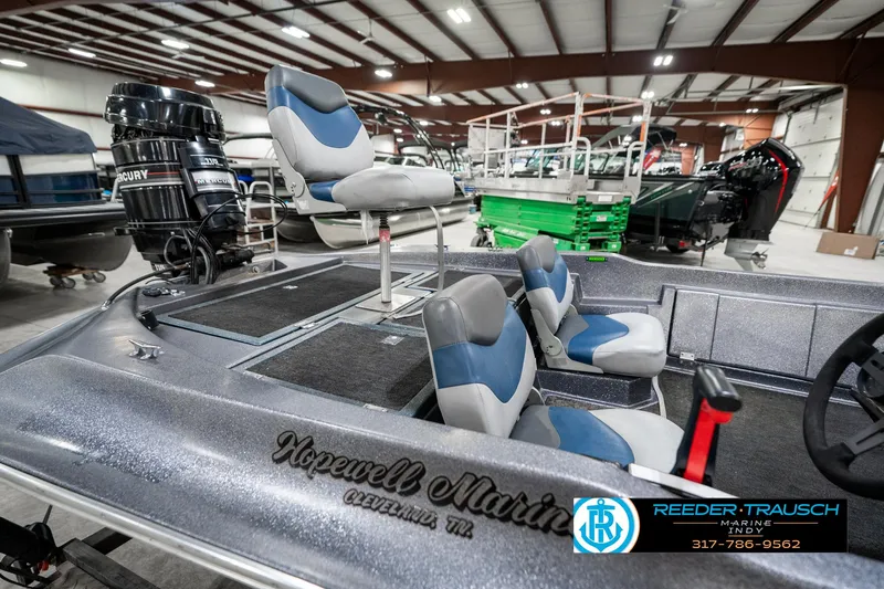Slide: The Image of 1986 Phantom Panther boat interior with blue and gray seats in a showroom. - 25