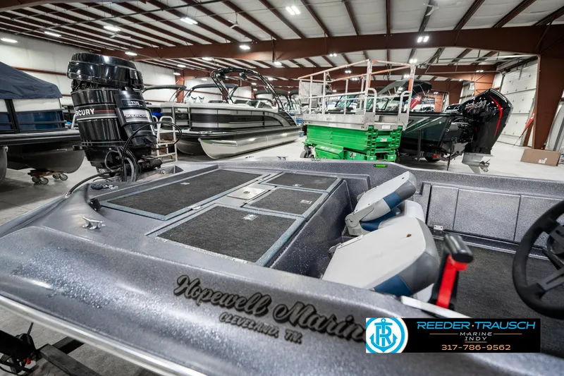 Slide: The Image of Interior of a 1986 Phantom Panther boat in a showroom with Mercury engine. - 26