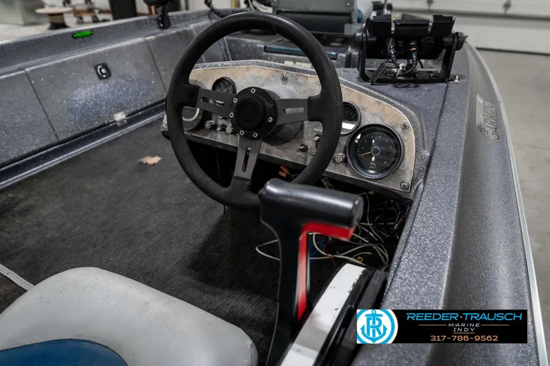 Slide: The Image of 1986 Phantom Panther boat dashboard with steering wheel and gauges, Reeder-Trausch Marine logo visible. - 30