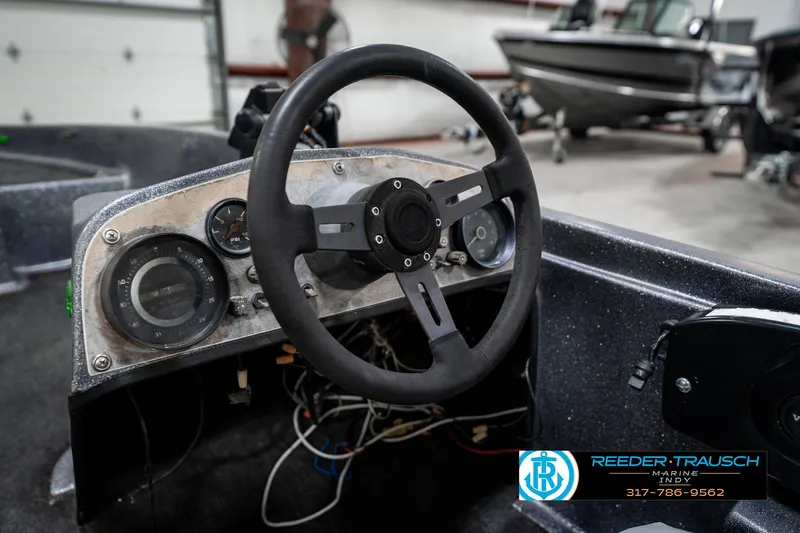 Slide: The Image of 1986 Phantom Panther boat dashboard with steering wheel and gauges in a garage setting. - 31