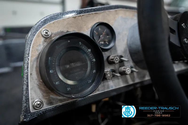 Slide: The Image of Dashboard of a 1986 Phantom Panther boat with vintage gauges and controls. - 32