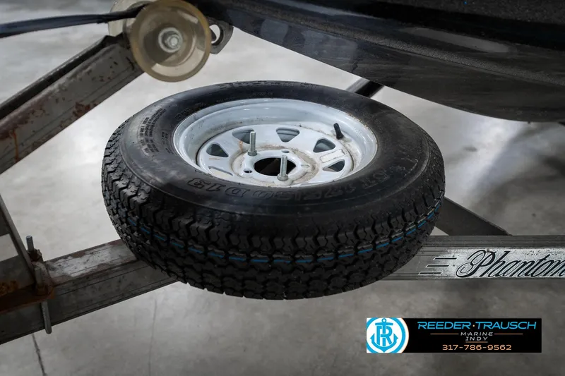 Slide: The Image of 1986 Phantom Panther trailer with spare tire, Reeder-Trausch Marine logo visible. - 40