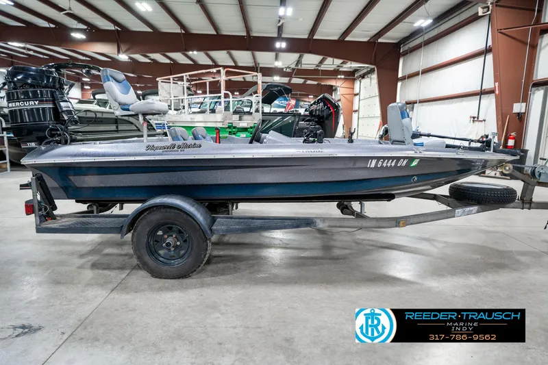 Slide: The Image of 1986 Phantom Panther boat on trailer in indoor showroom, featuring Mercury outboard motor. - 5