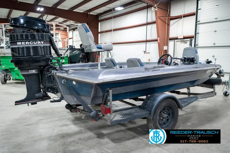 Slide: The Image of 1986 Phantom Panther boat with Mercury 115 outboard motor in a garage setting. - 6