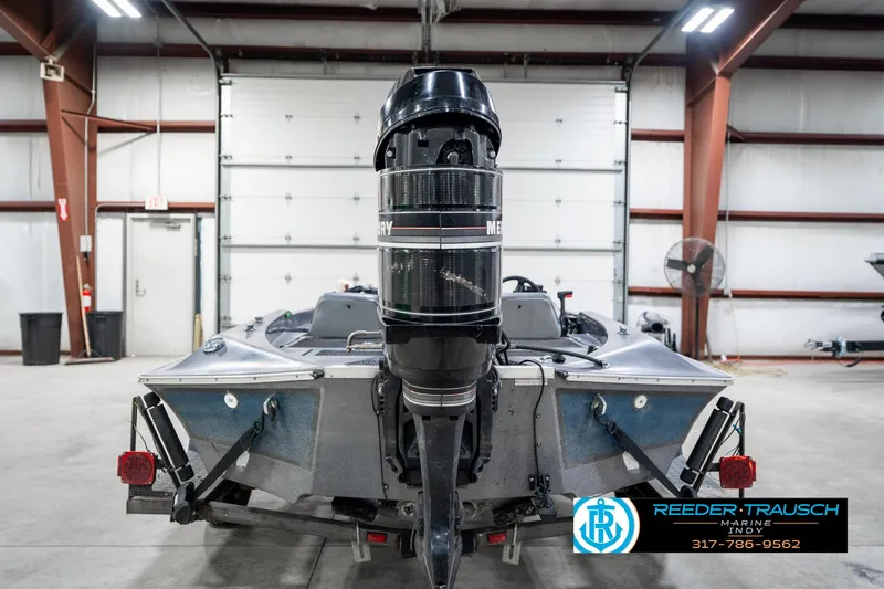 Slide: The Image of 1986 Phantom Panther boat with Mercury outboard motor in a garage setting. - 7