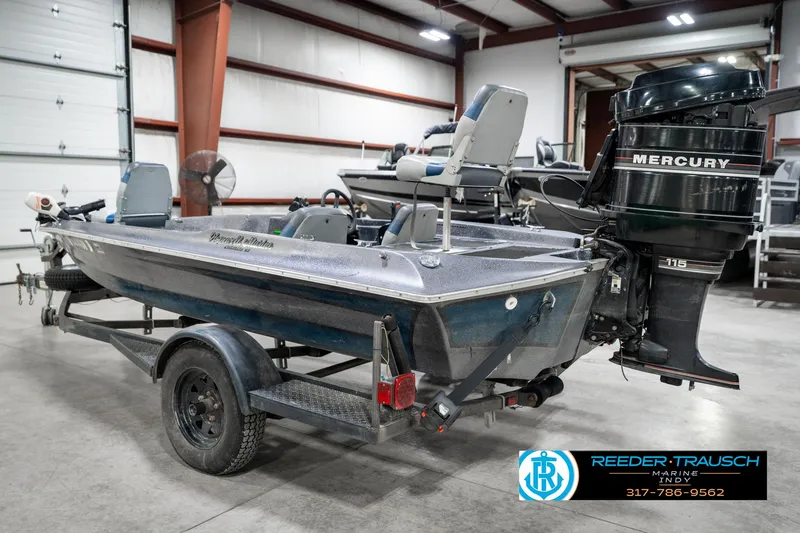 Slide: The Image of 1986 Phantom Panther boat with Mercury 115 outboard motor on trailer in warehouse. - 8