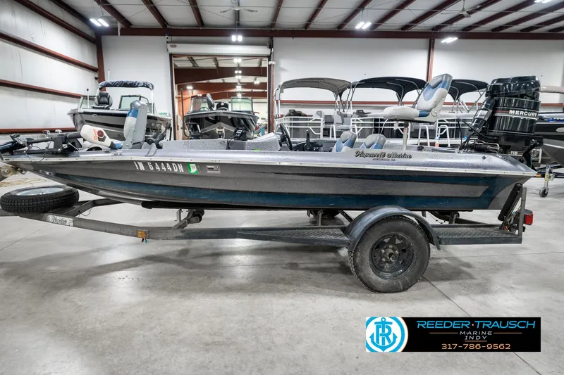 Slide: The Image of 1986 Phantom Panther boat on trailer in indoor showroom, featuring Mercury outboard motor. - 9