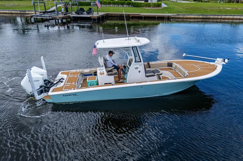 Slide: The Image of 2023 Tidewater 2700 Carolina Bay boat cruising on calm water, featuring modern design and amenities. - 10
