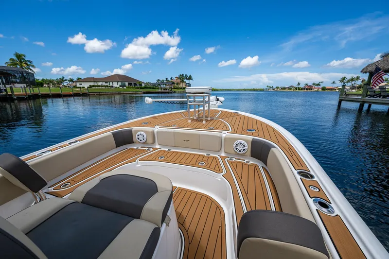 Slide: The Image of 2023 Tidewater 2700 Carolina Bay boat on serene water with clear blue sky. - 18