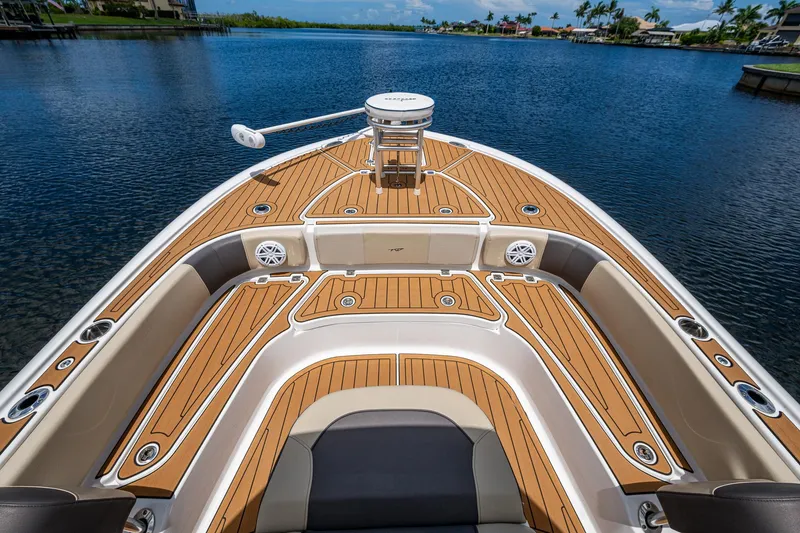 Slide: The Image of 2023 Tidewater 2700 Carolina Bay boat with teak deck, on calm water. - 20