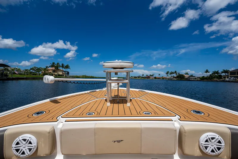 Slide: The Image of 2023 Tidewater 2700 Carolina Bay boat on a sunny day, featuring a spacious deck. - 21