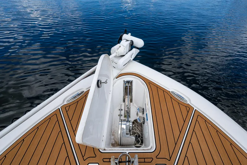 Slide: The Image of Bow of 2023 Tidewater 2700 Carolina Bay boat on calm water. - 24