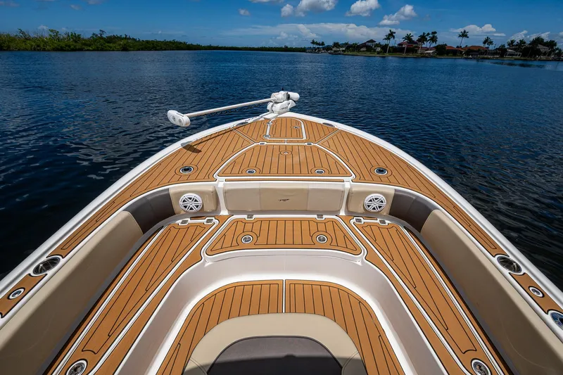 Slide: The Image of 2023 Tidewater 2700 Carolina Bay boat with teak deck on calm water. - 25