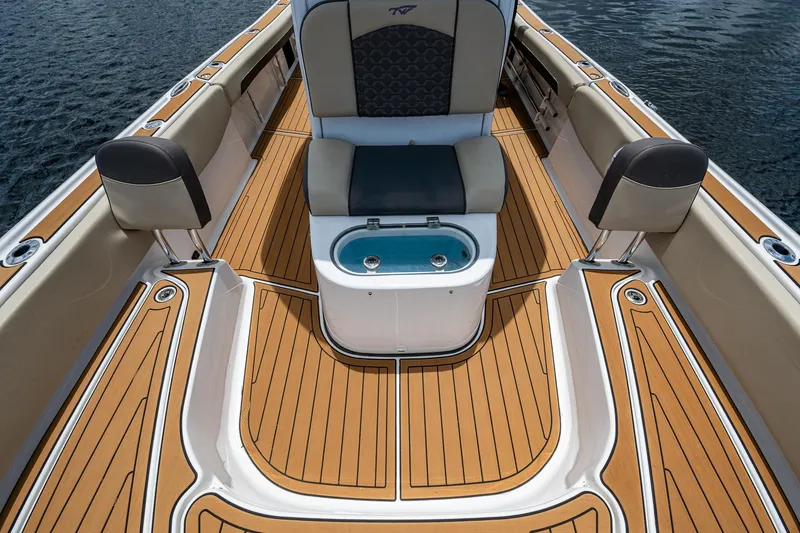 Slide: The Image of 2023 Tidewater 2700 Carolina Bay boat interior with teak flooring and cushioned seating. - 27