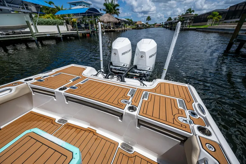 Slide: The Image of 2023 Tidewater 2700 Carolina Bay boat with dual Mercury engines on a sunny waterway. - 31