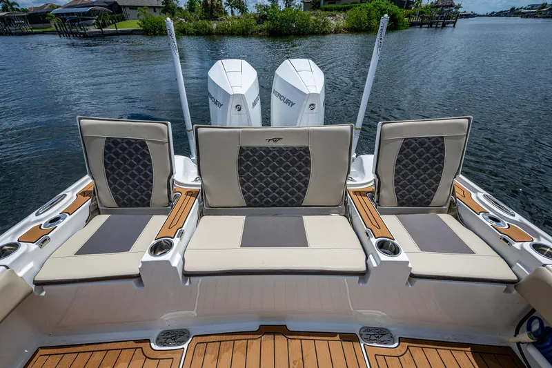 Slide: The Image of 2023 Tidewater 2700 Carolina Bay boat with cushioned seating and dual Mercury engines. - 34