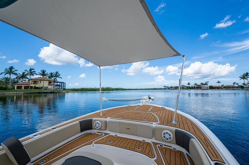 Slide: The Image of 2023 Tidewater 2700 Carolina Bay boat on serene water with canopy and scenic view. - 39