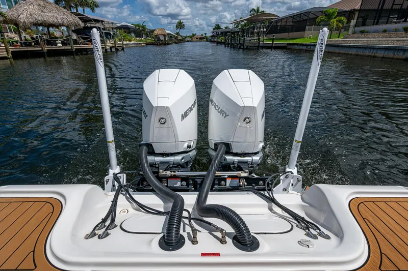 Slide: The Image of 2023 Tidewater 2700 Carolina Bay boat with dual Mercury engines on a scenic waterway. - 41