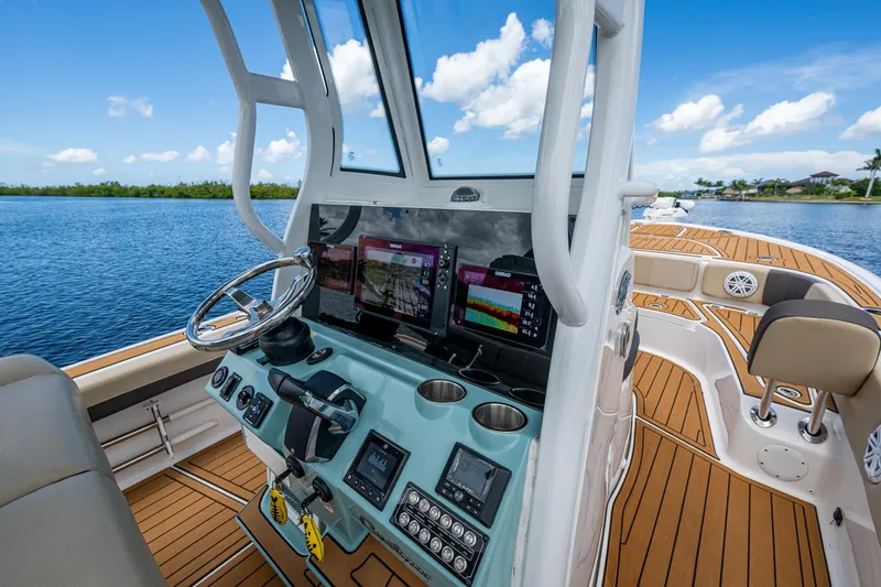 Slide: The Image of 2023 Tidewater 2700 Carolina Bay boat interior with advanced navigation system and teak flooring. - 49