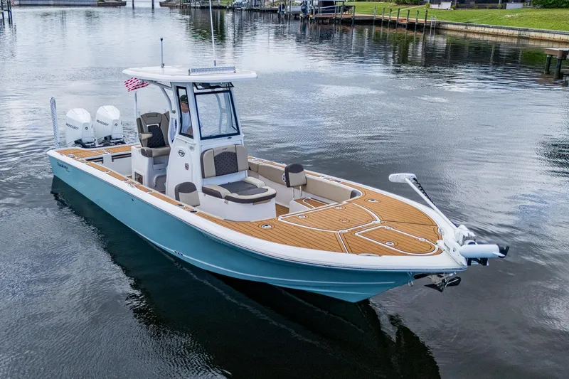 Slide: The Image of 2023 Tidewater 2700 Carolina Bay boat on calm water, featuring sleek design and modern amenities. - 7