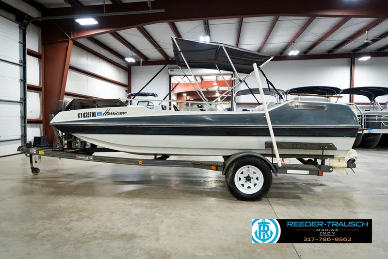 Slide: The Image of 1987 Hurricane 176 Deck Boat on trailer in indoor showroom. - 11