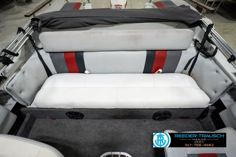 Slide: The Image of 1987 Hurricane 176 Deck Boat interior with white and gray seating, red accents, and carpeted flooring. - 22