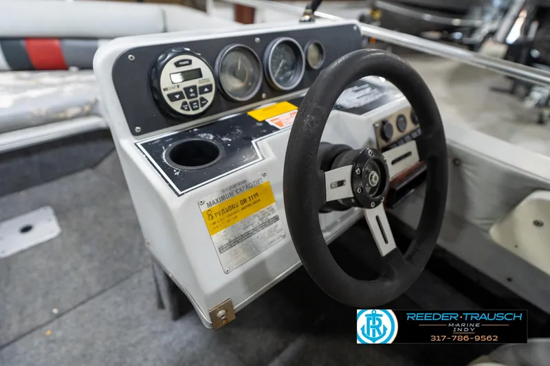 Slide: The Image of Control panel of a 1987 Hurricane 176 Deck Boat with steering wheel and gauges. - 24