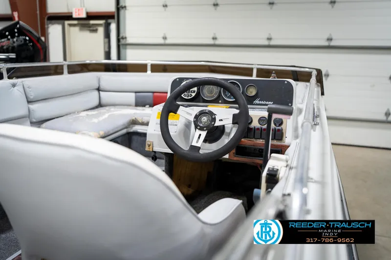 Slide: The Image of Interior of a 1987 Hurricane 176 Deck Boat with steering wheel and control panel. - 25