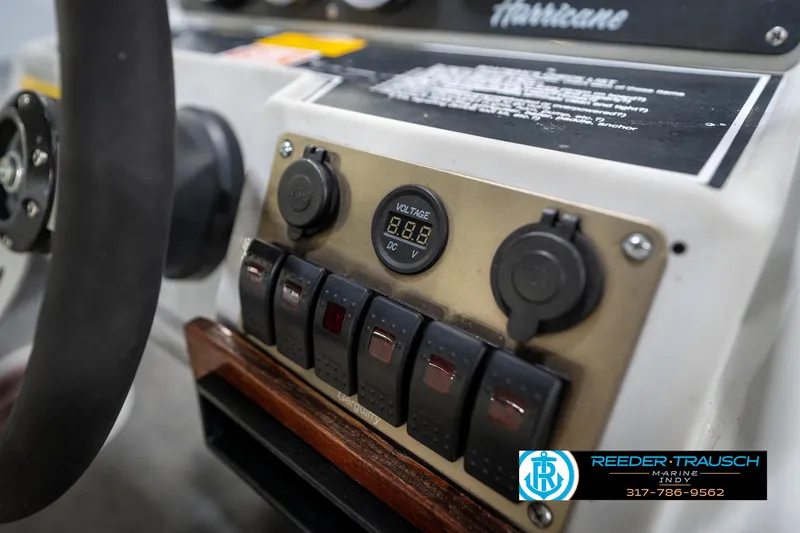 Slide: The Image of Control panel of a 1987 Hurricane 176 Deck Boat with voltage display and switches. - 27
