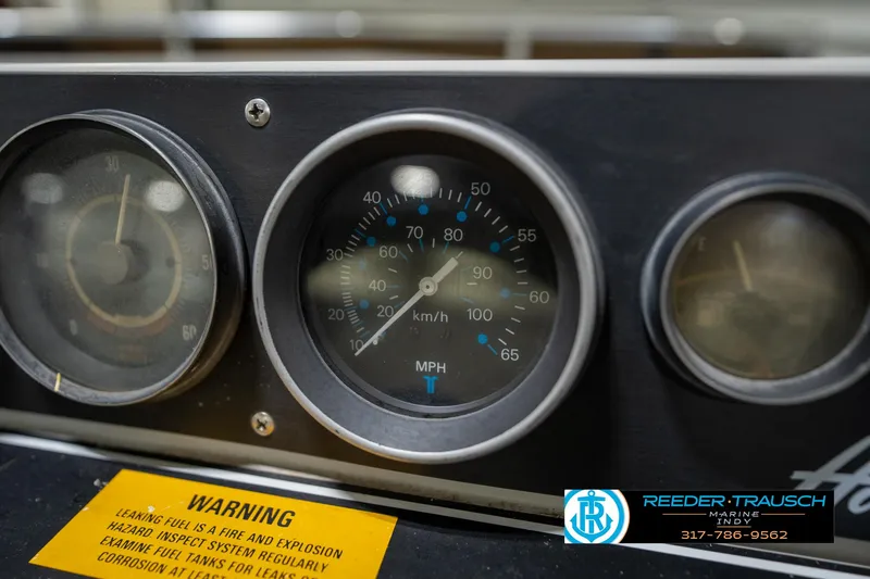 Slide: The Image of Dashboard of a 1987 Hurricane 176 Deck Boat with speedometer and warning label. - 28