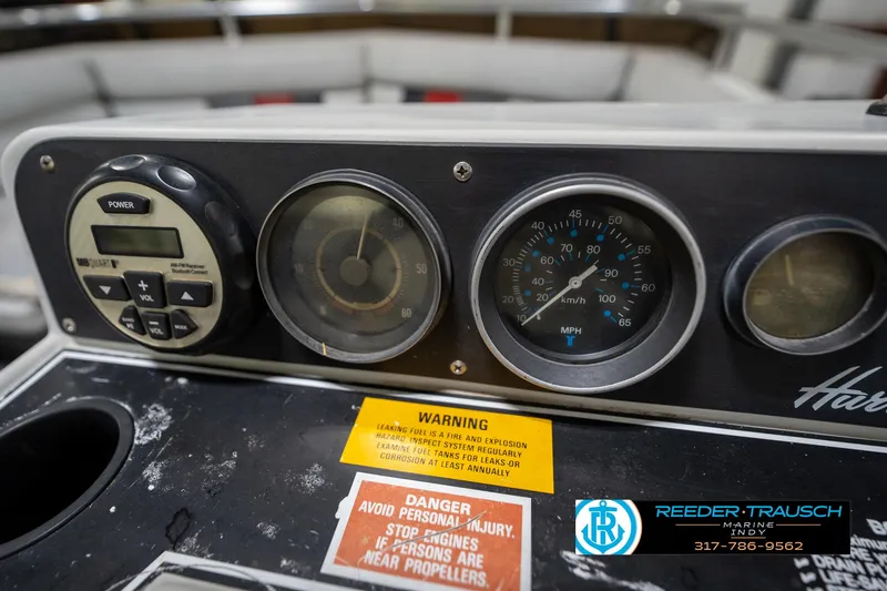 Slide: The Image of Dashboard of a 1987 Hurricane 176 Deck Boat with gauges and warning labels. - 30