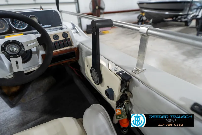 Slide: The Image of 1987 Hurricane 176 Deck Boat cockpit with steering wheel and control panel. - 31