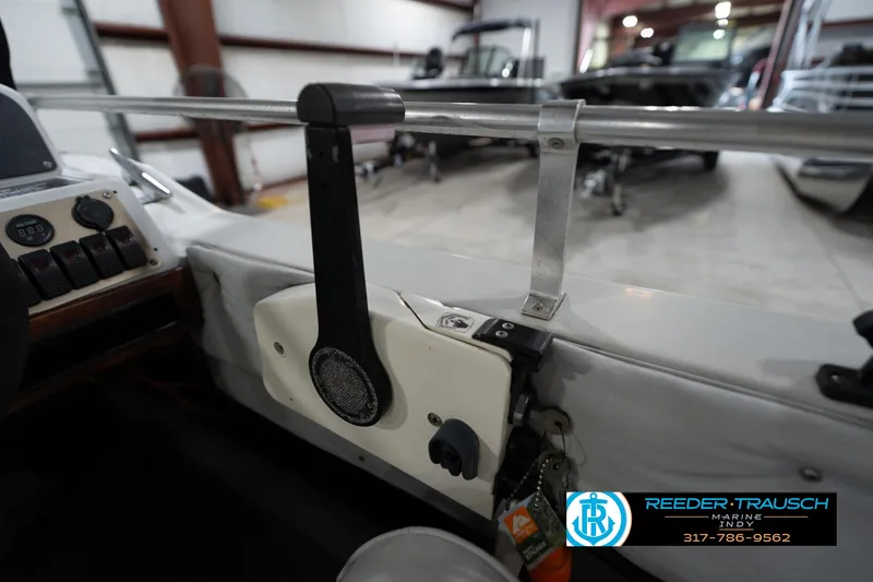 Slide: The Image of 1987 Hurricane 176 Deck Boat interior with control panel and throttle lever. - 32