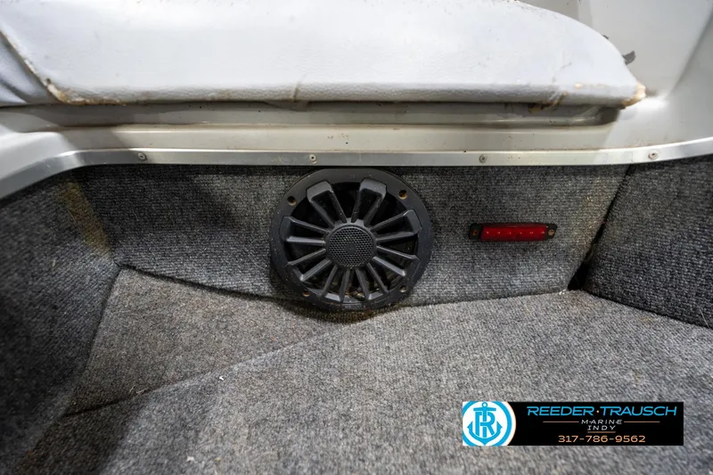 Slide: The Image of Interior of 1987 Hurricane 176 Deck Boat with speaker and carpeted flooring. - 35