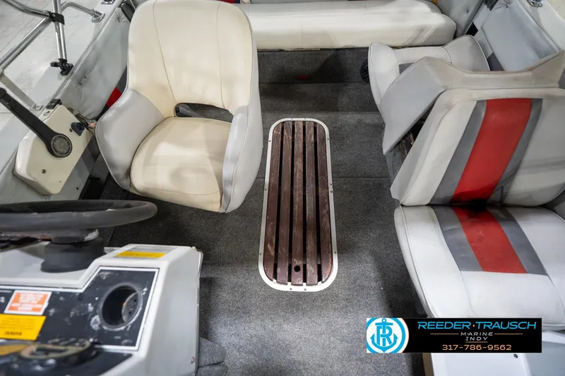 Slide: The Image of Interior of a 1987 Hurricane 176 Deck Boat with seating and steering wheel. - 36