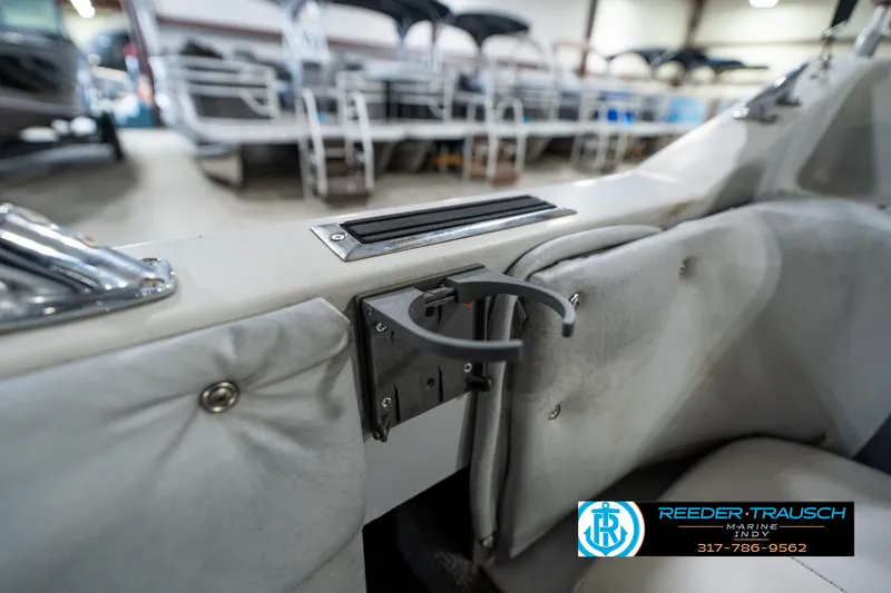 Slide: The Image of 1987 Hurricane 176 Deck Boat interior with cup holder and padded seating. - 37